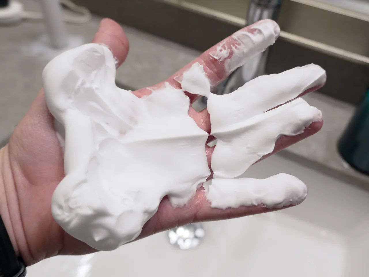 Barbasol foam spread across my palm and fingers, holding distinct peaks