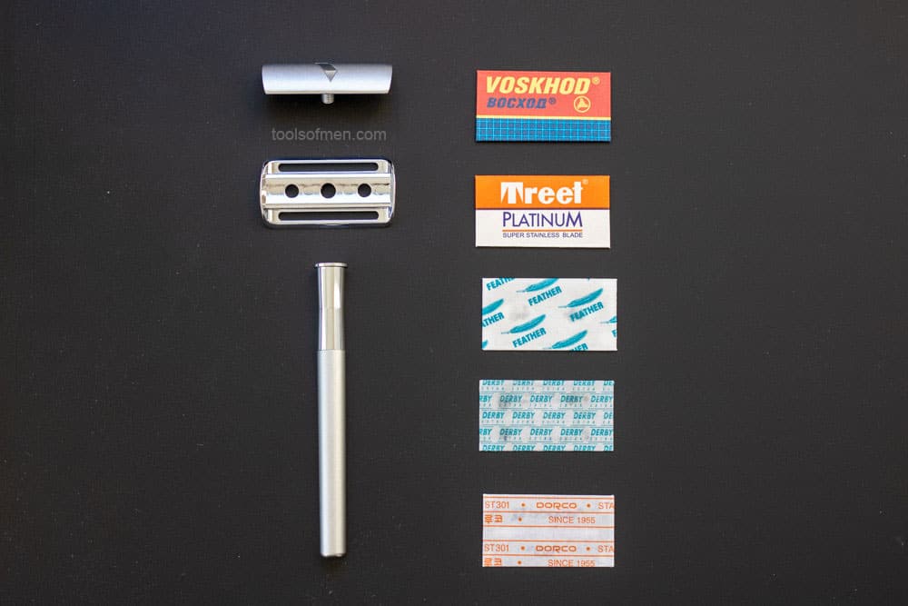 bevel razor next to several safety razor blades