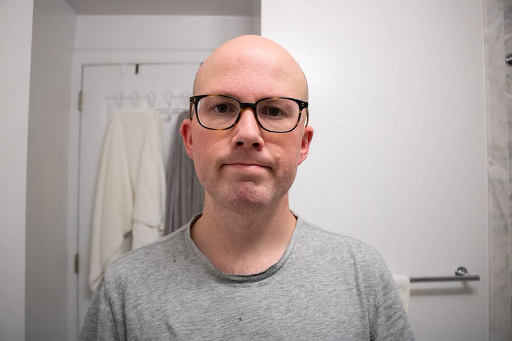 man showing face after shaving with body shop shaving cream