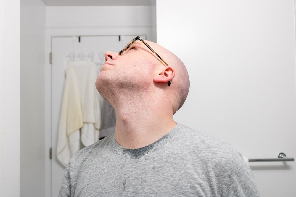 man looking up to show neck after shaving with gillette mach3
