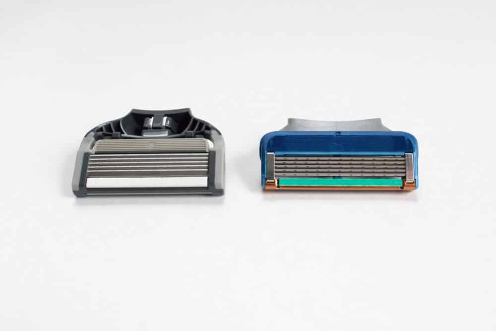cartridge of harry and gillettes razor next to each other