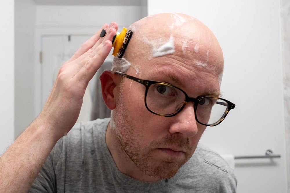 man shaving side of head with headblade moto