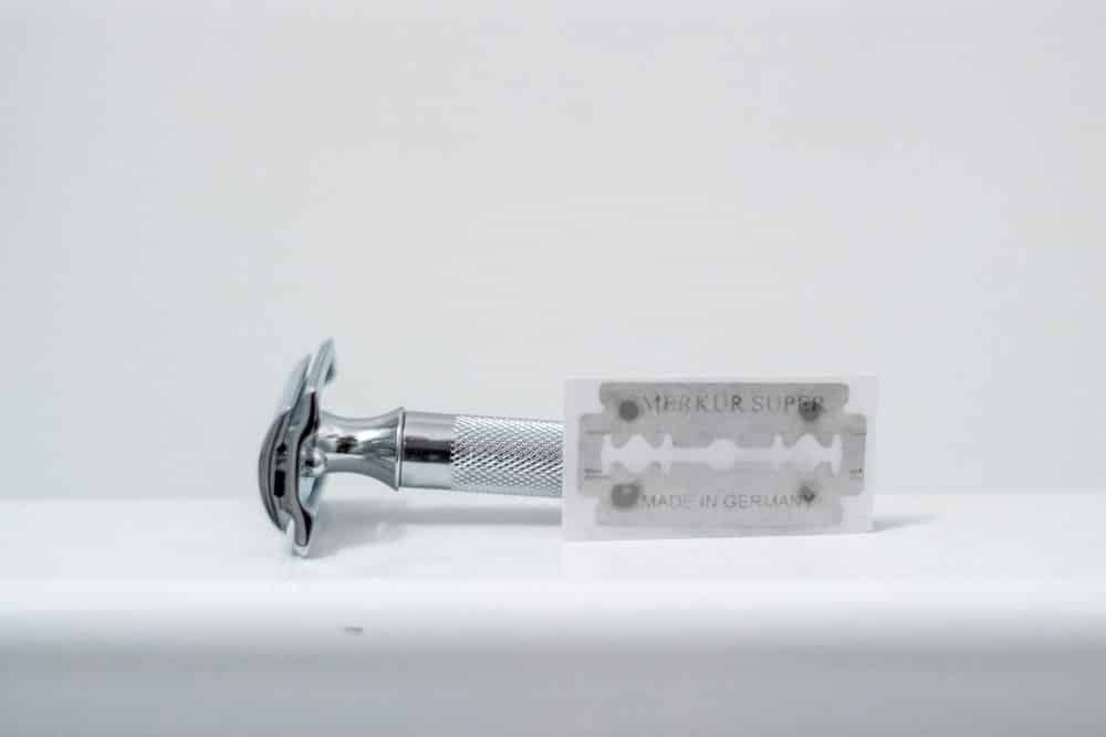 merkur 34c next to razor blade in wrapper