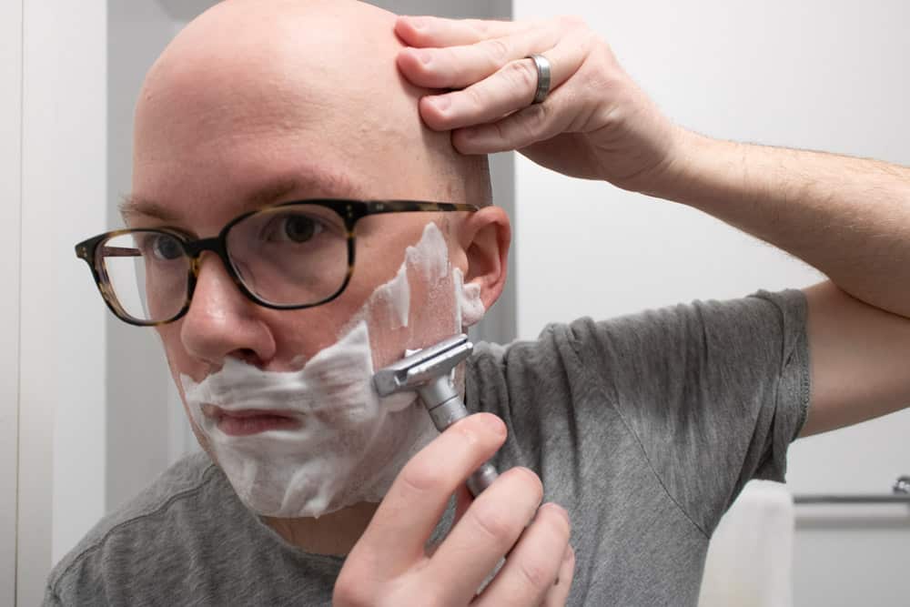 man shaving cheek with merkur futur