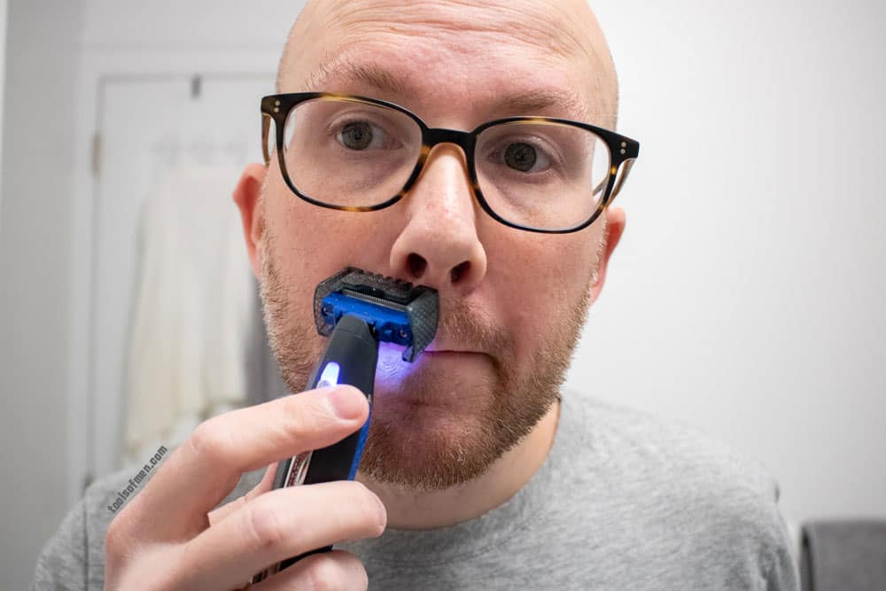 man shaving mustache with microtouch solo comb attached