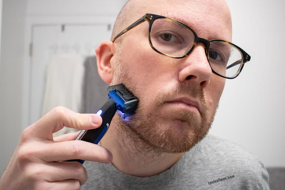 man shaving right side cheek