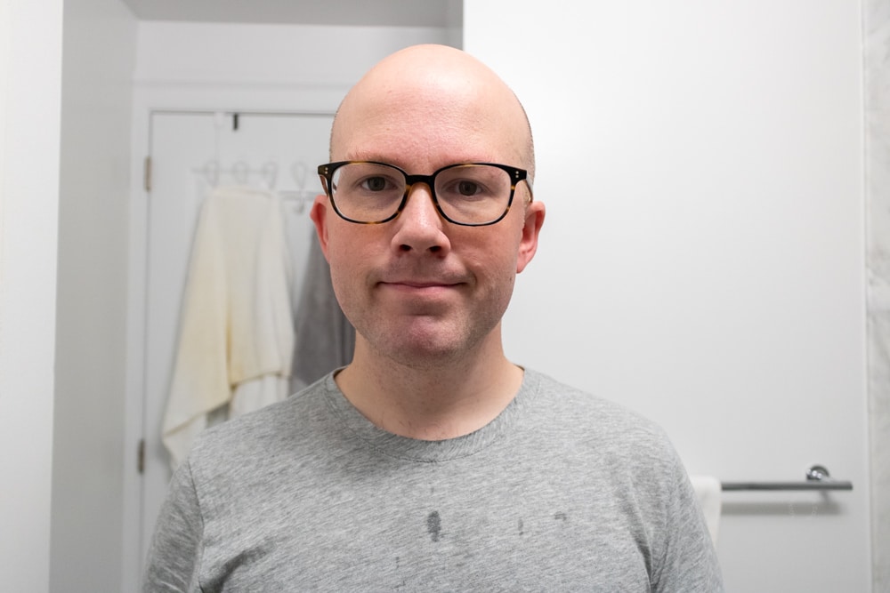 man smiling while showing face after using the microtouch tough blade
