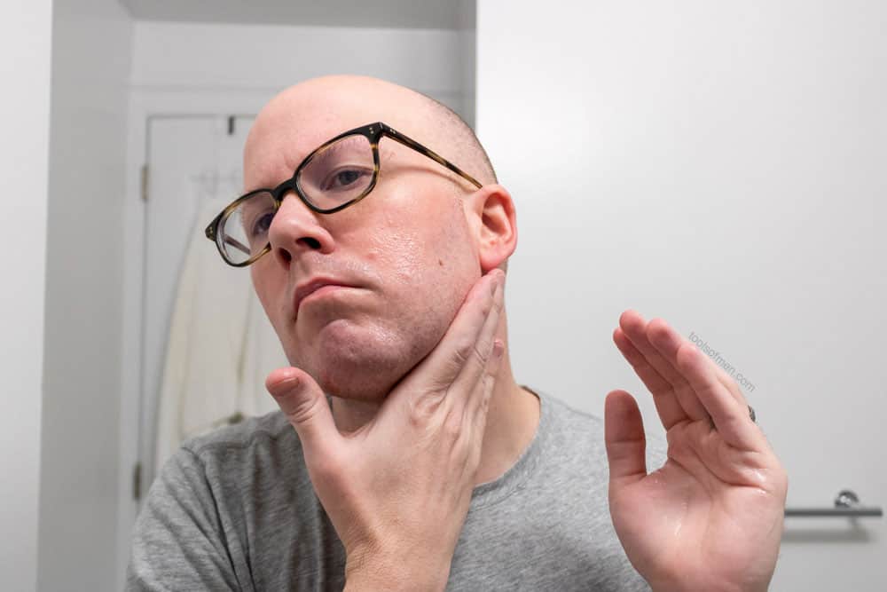 man applying balm to face