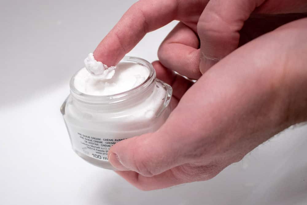 finger scooping out proraso pre shave cream