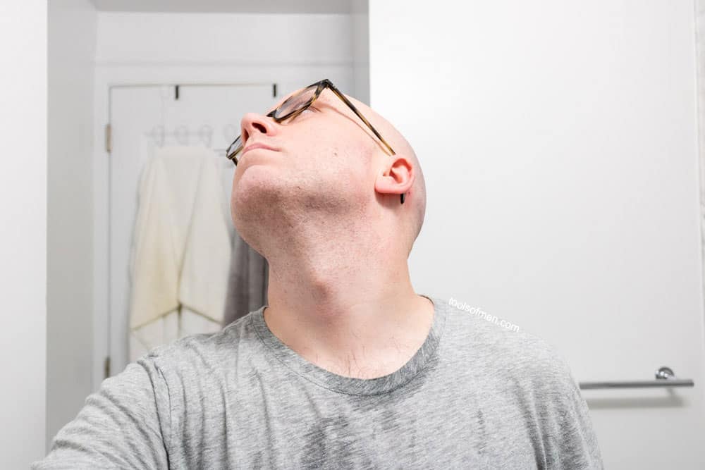 man exposing neck to demonstrate shave quality of the razor