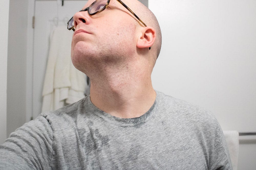 man looking up to expose skin to demonstrate how the pre shave oil performed