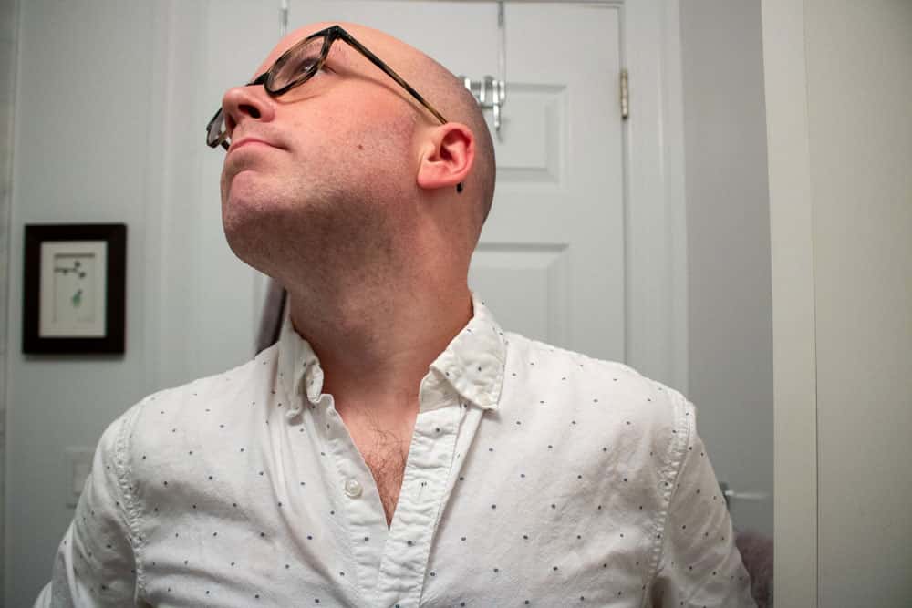 man looking up to expose neck to demonstrate shave results