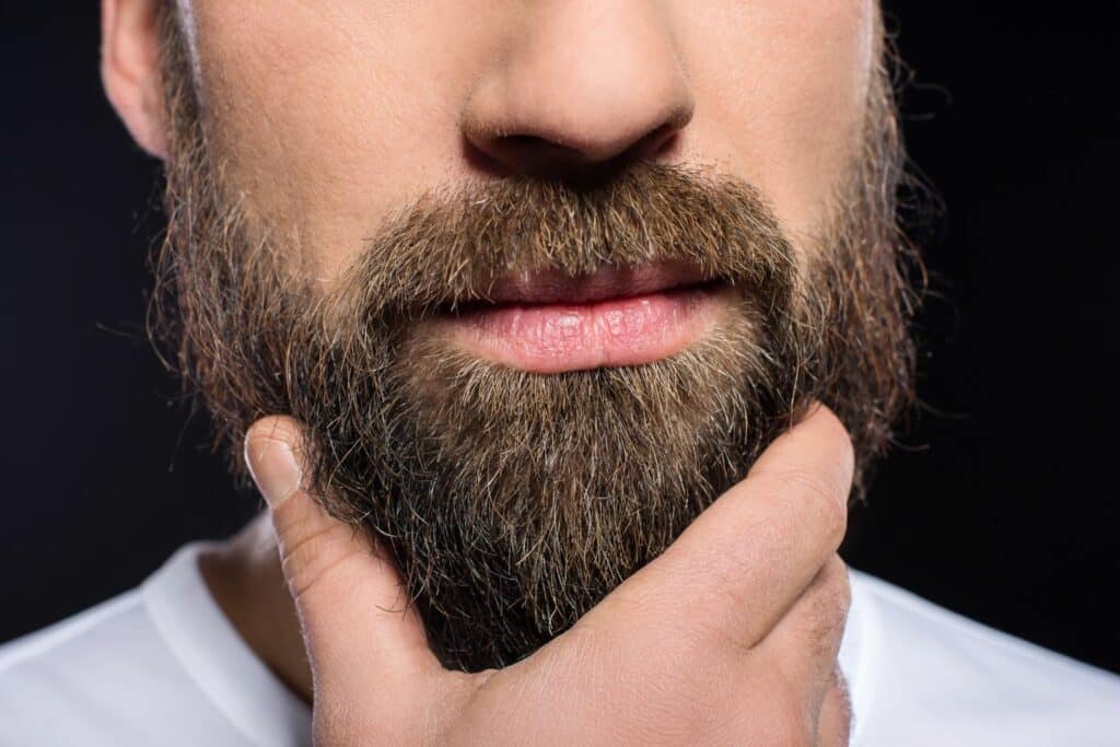 man stroking beard