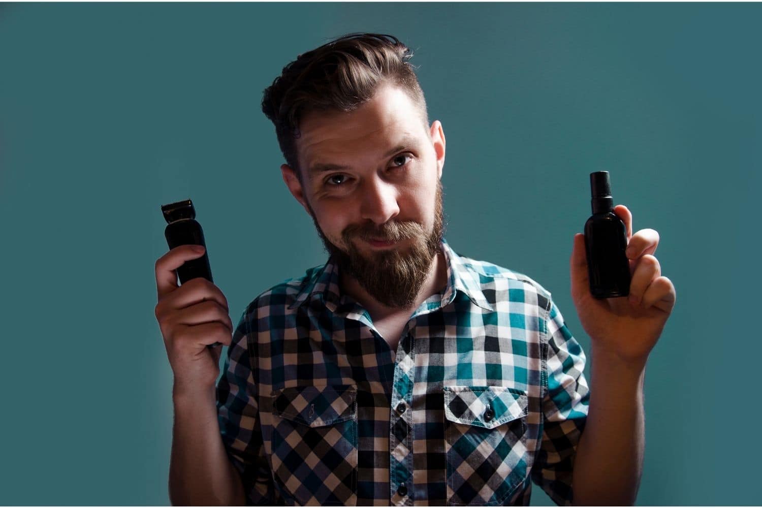 a man holding two grooming products in both hands