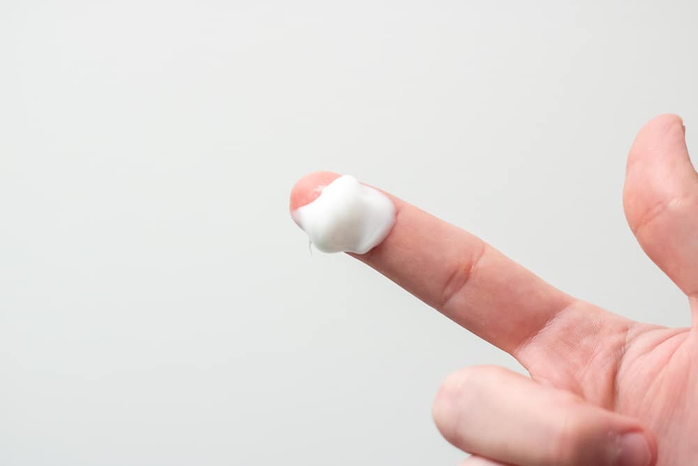 beast skincare lotion on finger tip