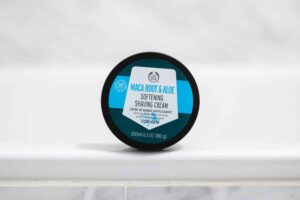 body shop shaving cream sitting on bathtub ledge