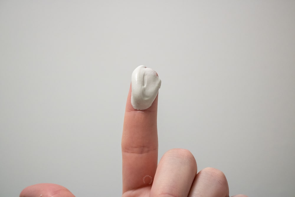 cardon cleanser on fingertip to demonstrate thickness