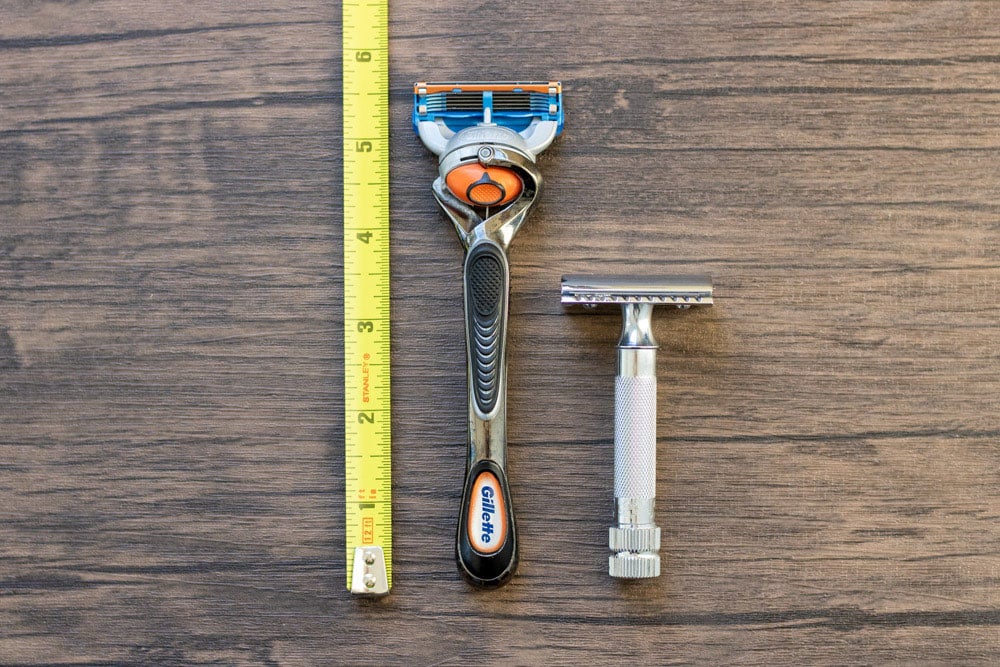 cartridge and safety razor next to measuring tape