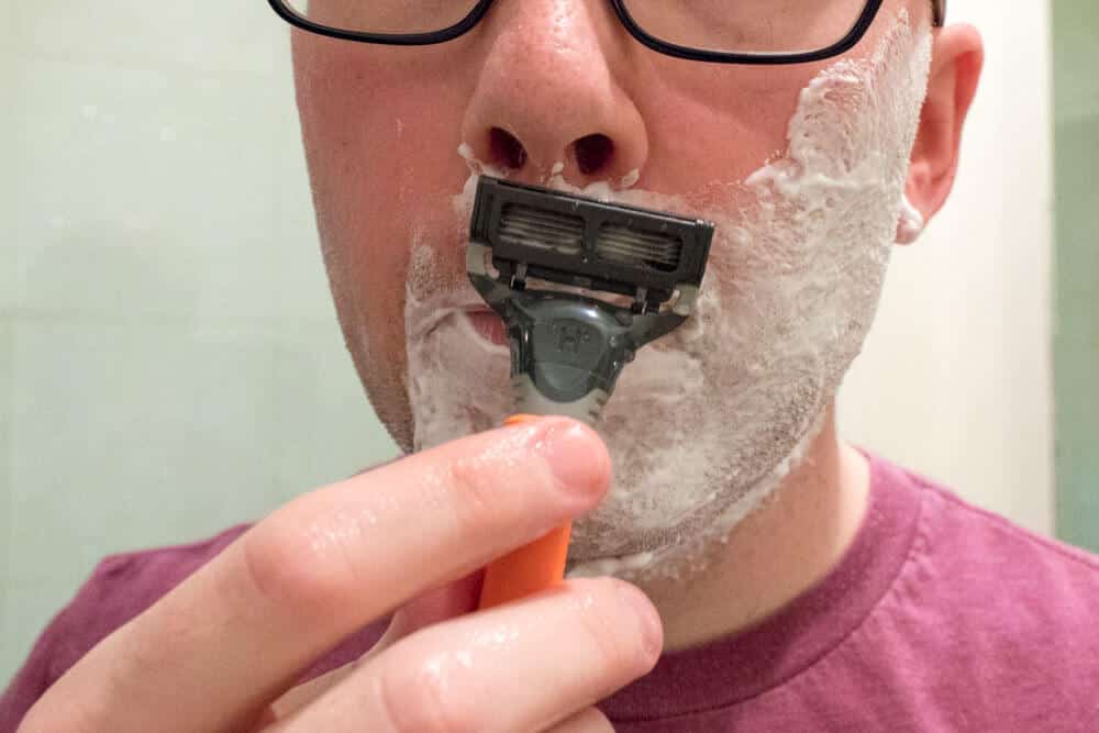 closeup of a man shaving mustache with harrys razor