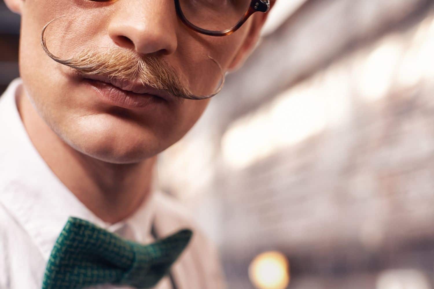 closeup of a man with a distinct handlebar mustache