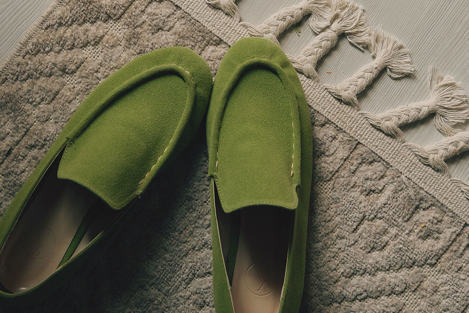 green slippers on the rug