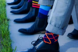 group of men wearing colorful socks