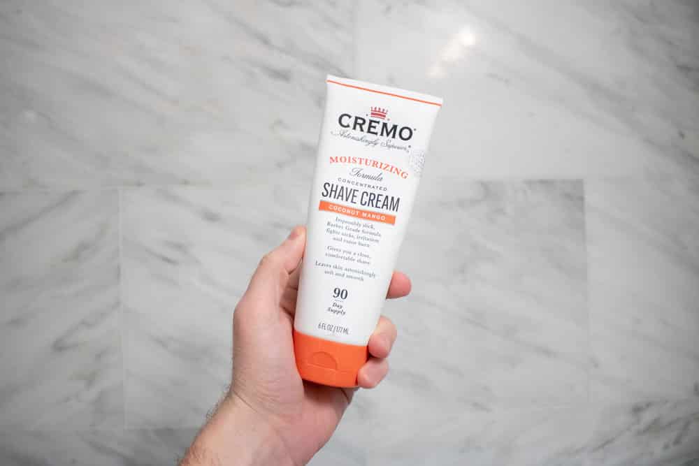 hand holding CREMO shaving cream