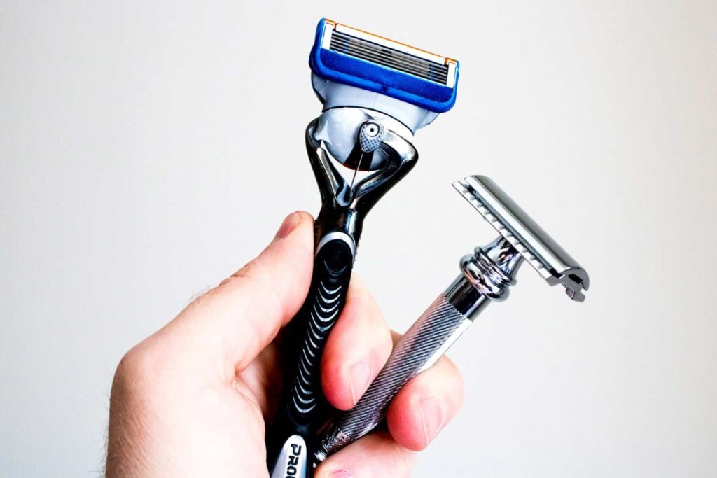 hand holding both a safety and cartridge razor