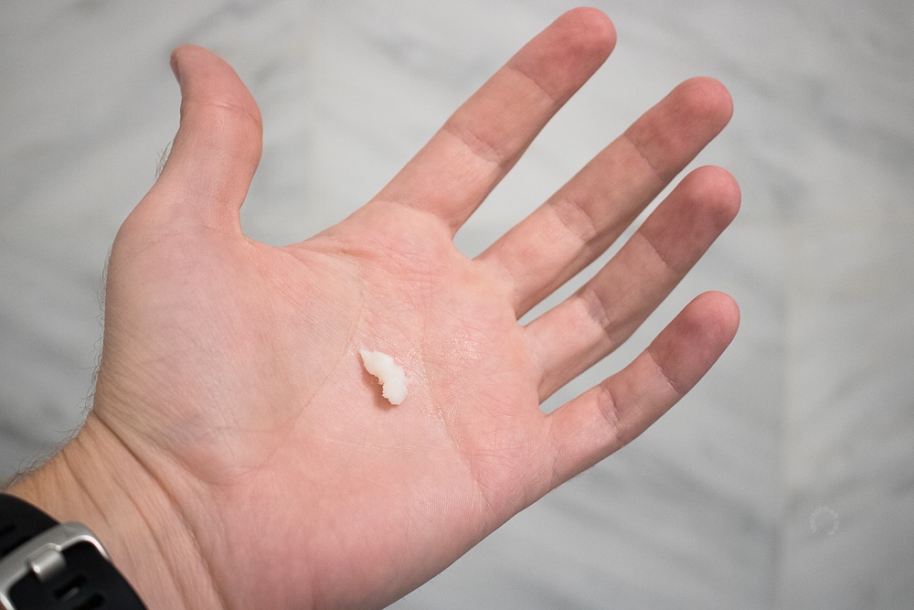 hand with a white balm in a the center of palm