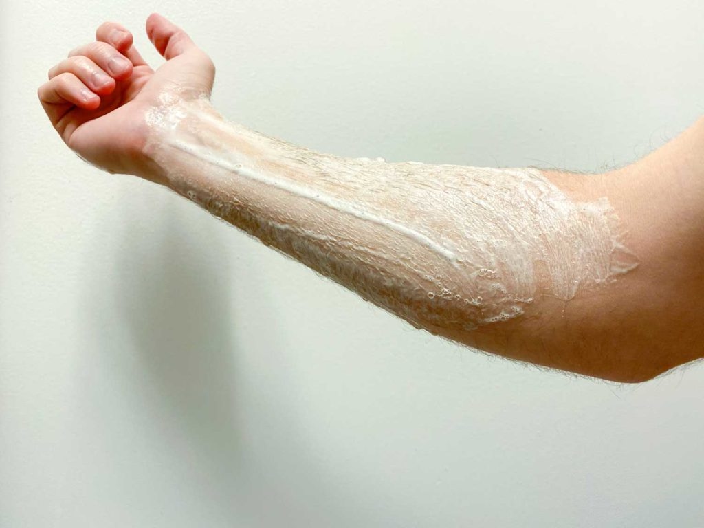 lathering huron body wash on forearm