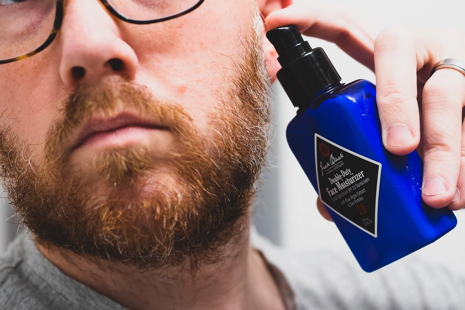 man about to pump lotion on beard