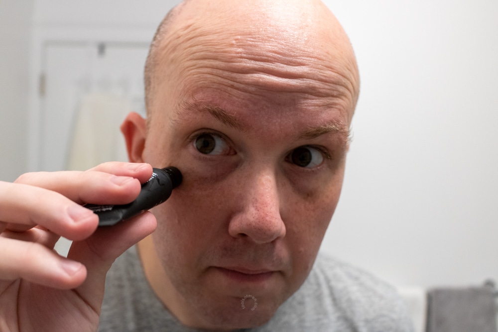 man applying cardon eye cream