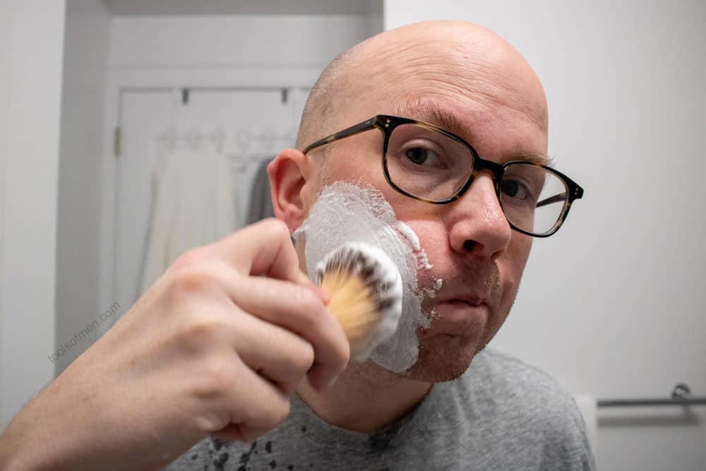 man applying shaving cream with brush