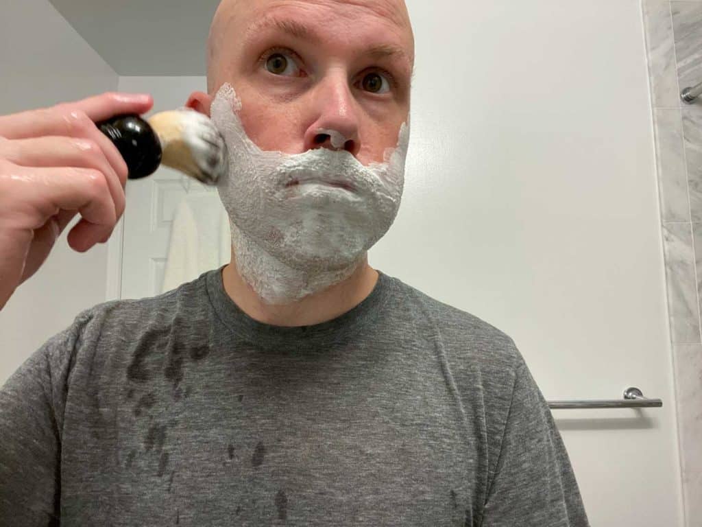man applying the shave brush to his face