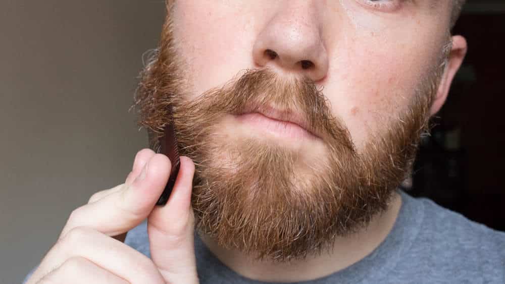 man combing his beard 1