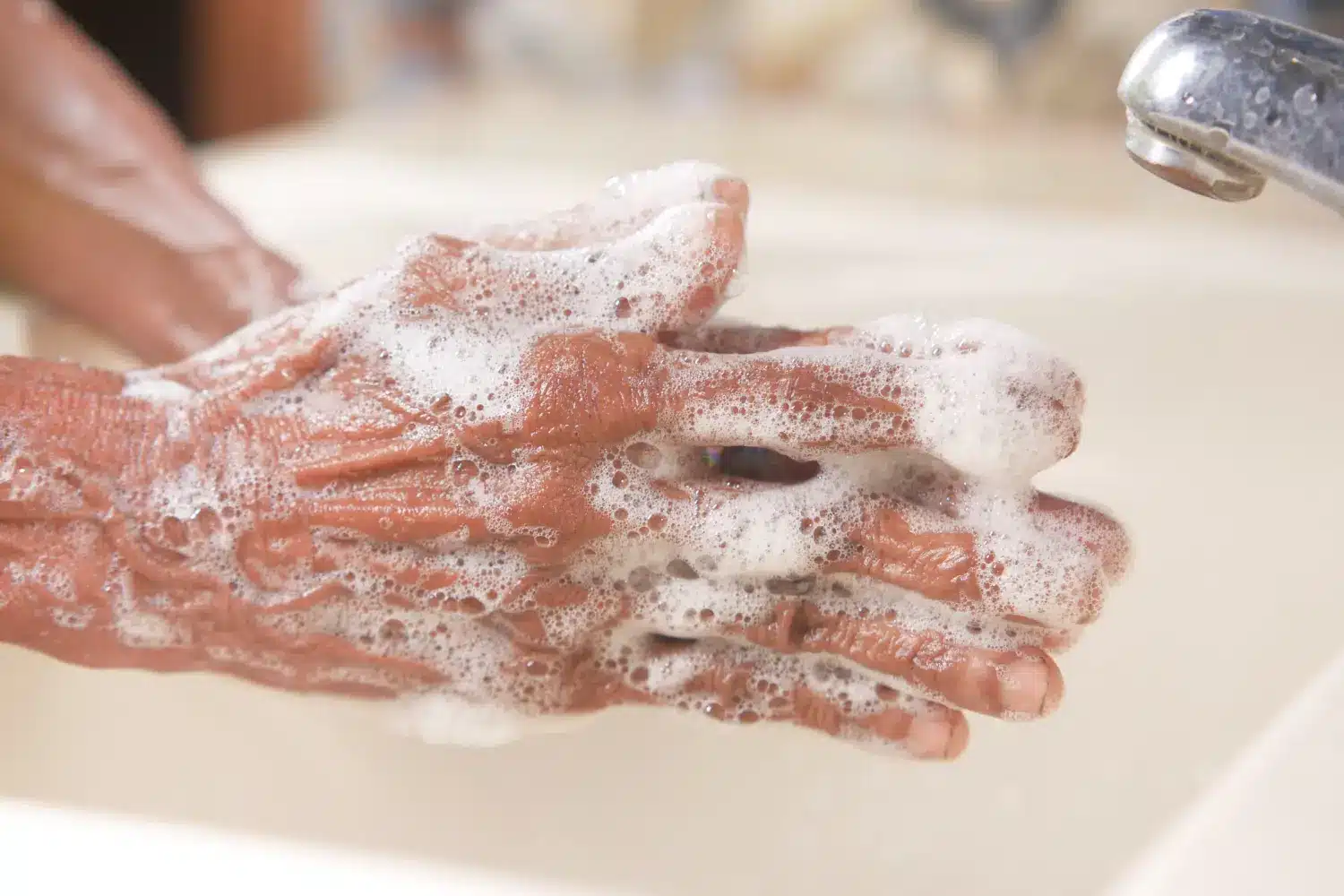 man lathering soap with hands