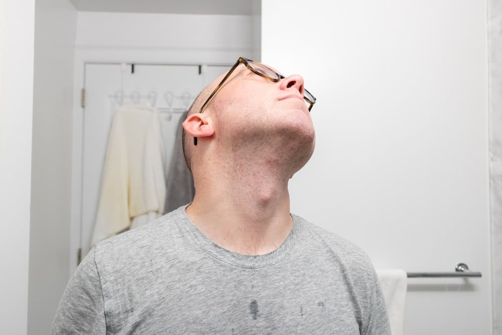 man looking up to expose neck to demonstrate results of the microtouch tough blade