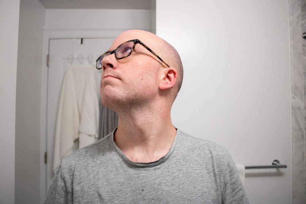 man looking up to show neck after using body shop shaving cream