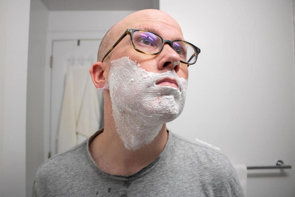 man looking up with a dry looking shaving cream lather 1