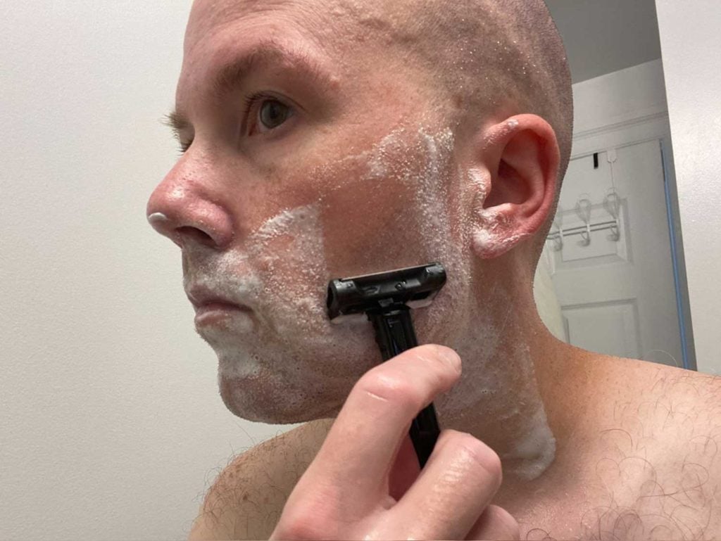 man making a second pass with the oneblade core on cheek