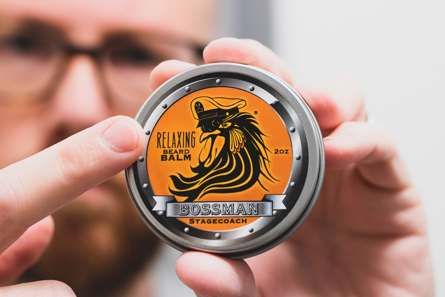 man pointing to label that says relaxing beard balm