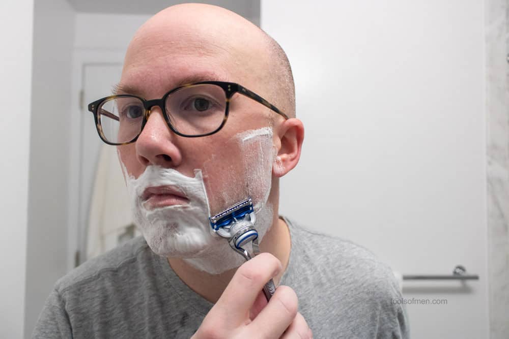 man shaving cheek with gillette skinguard