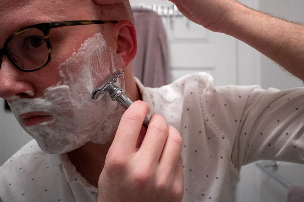 man shaving cheek with merkur 38c