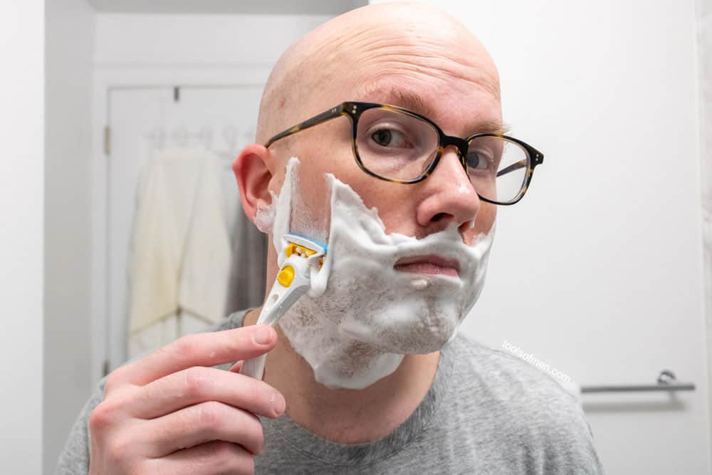 man shaving cheek with schick stubble eraser