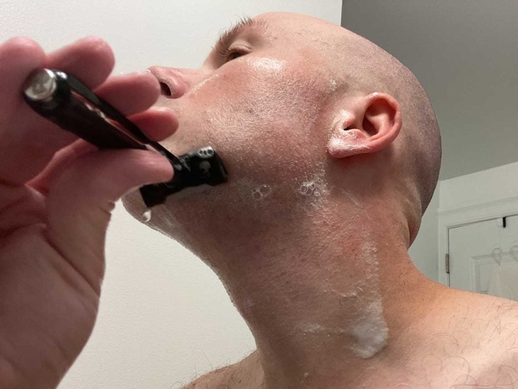 man shaving chin