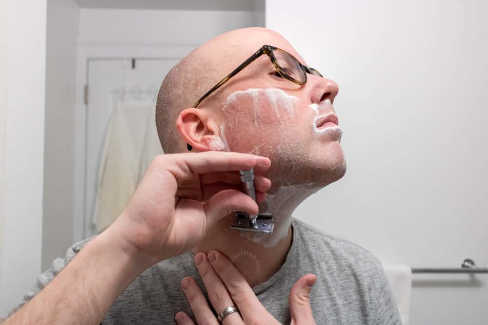 man shaving his neck with the merkur 37c