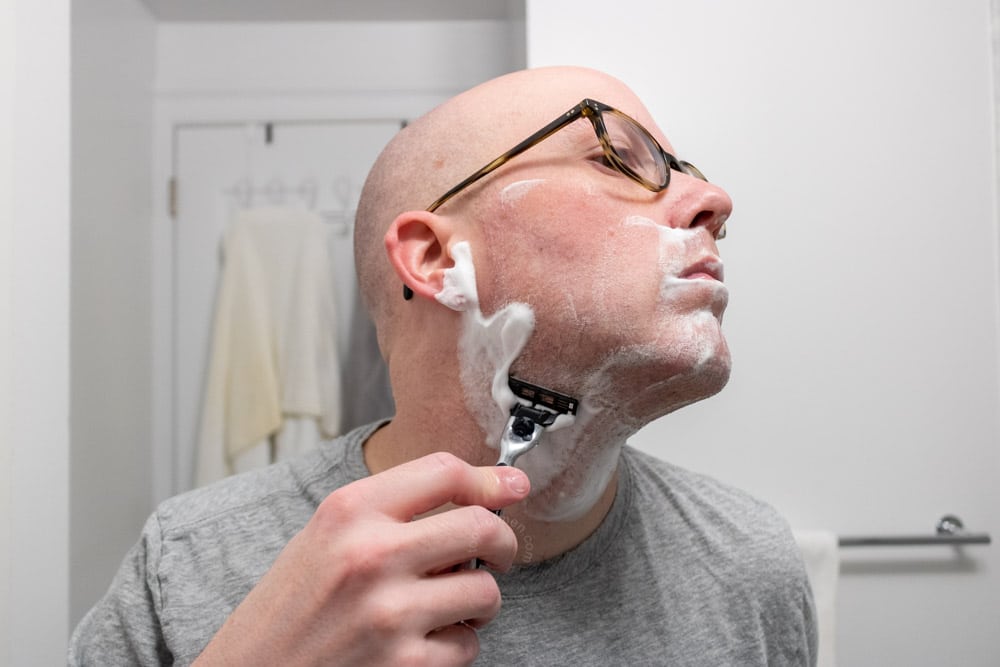 man shaving neck with gillette mach3