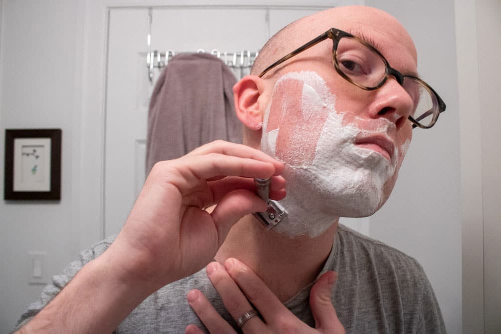man shaving neck with merkur 34c