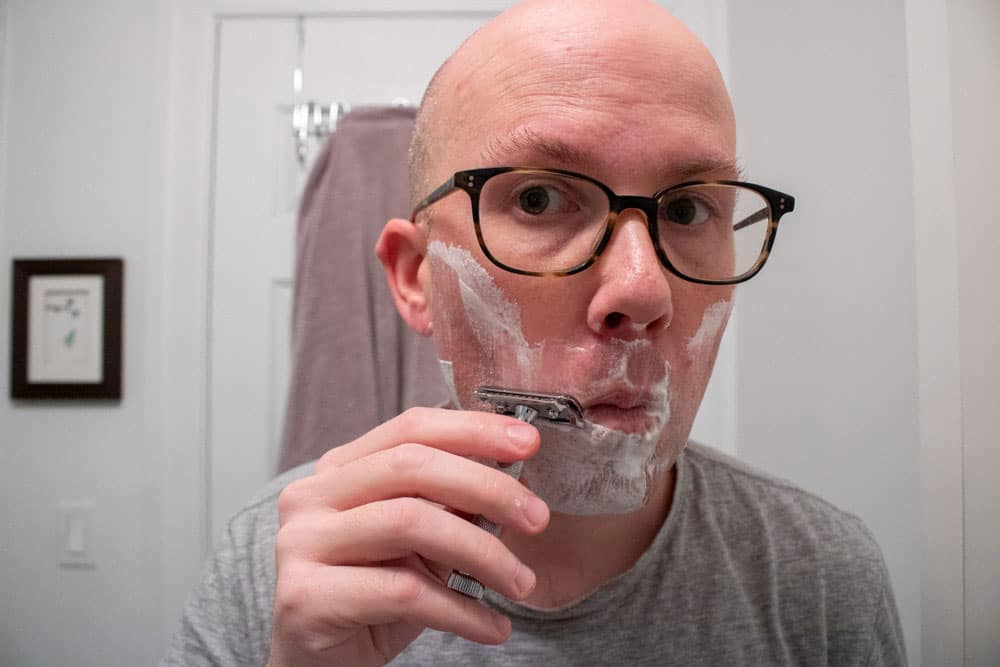 man shaving next to mouth with merkur 34c