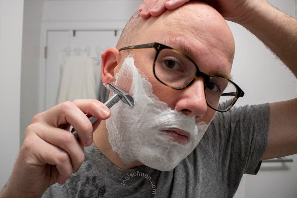 man shaving with bevel safety razor 5